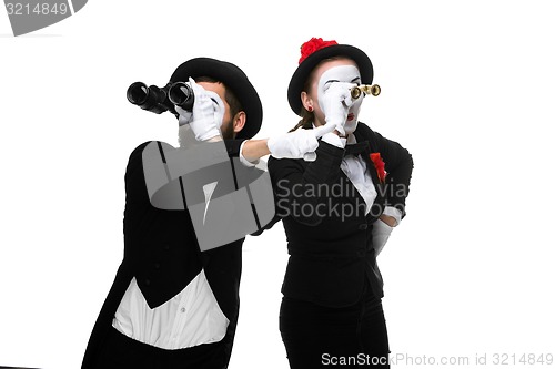 Image of Two memes as business people looking through binoculars 