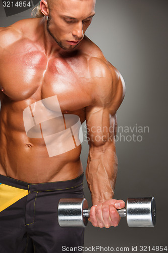 Image of Attractive male body builder on gray background