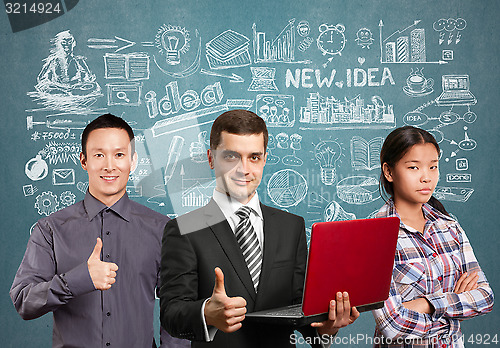 Image of Asian team and male in suit with laptop in his hands