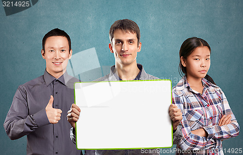 Image of Asian team and male with write board in his hands