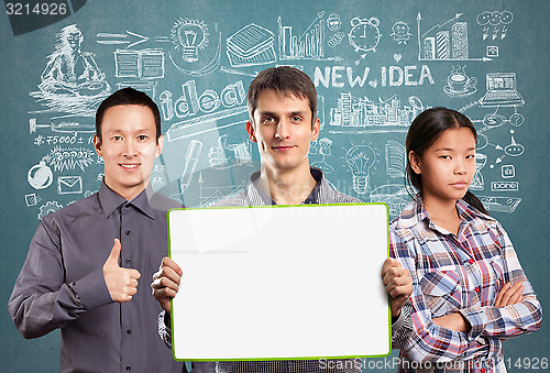 Image of Asian team and male with write board in his hands