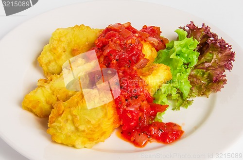 Image of Fried battered fish fillet on white plate