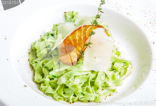 Image of green pasta with grilled fish