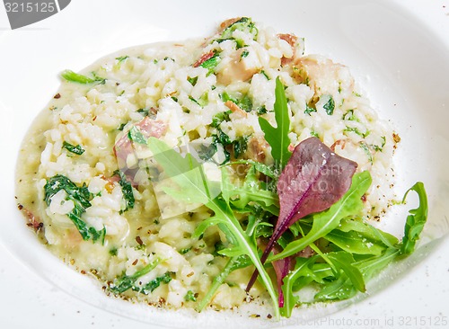 Image of risotto with smoked meat, spinach, parmesan cheese 