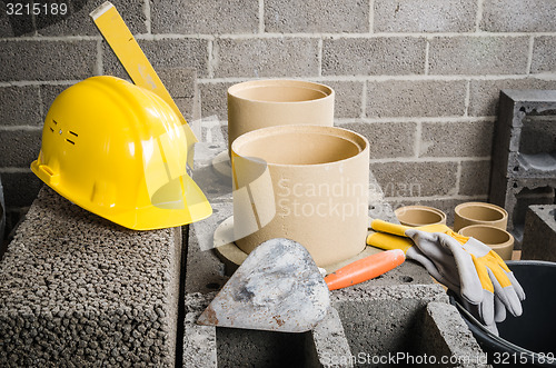 Image of Parts and tools for the construction of modular ceramic chimney in the house