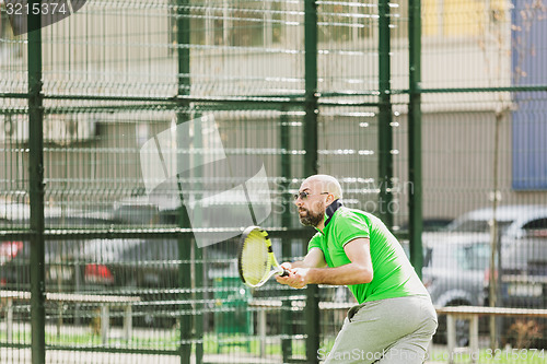 Image of man play tennis outdoor