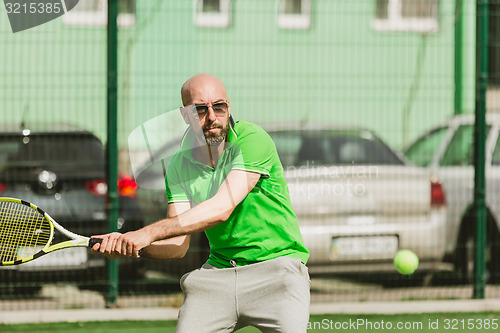 Image of man play tennis outdoor