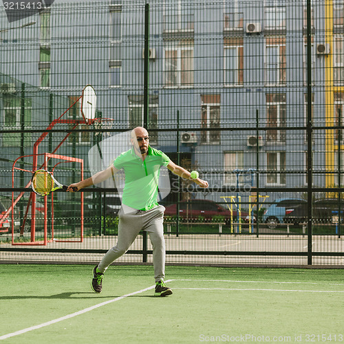 Image of man play tennis outdoor