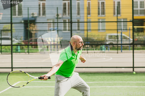 Image of man play tennis outdoor