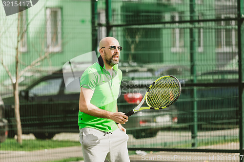 Image of man play tennis outdoor