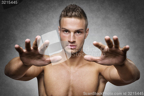Image of Athlete holds up his hands