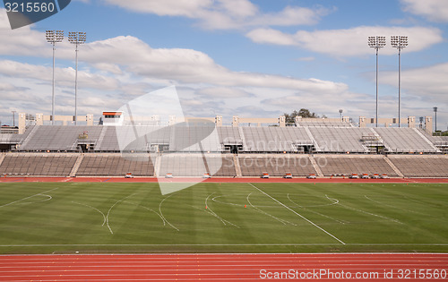 Image of College Level Track Stadium Puffy Clouds Blue Sky