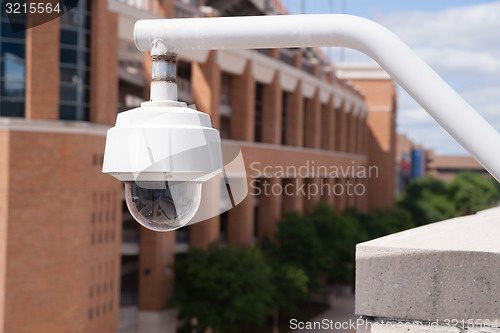 Image of Video Security Camera Housing Mounted High on College Campus