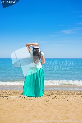 Image of Brunette with long hair turned away