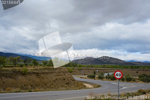 Image of Zigzag road in Spain with snow mountains