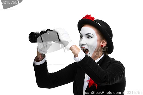 Image of Portrait of the surprised and joyful mime with binoculars