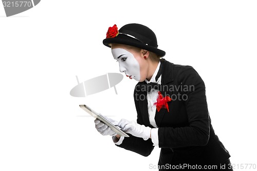 Image of business woman in the image mime holding tablet PC