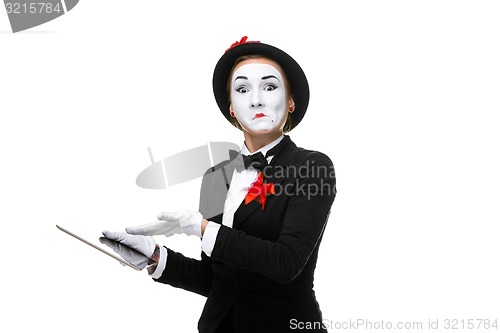 Image of business woman in the image mime holding tablet PC