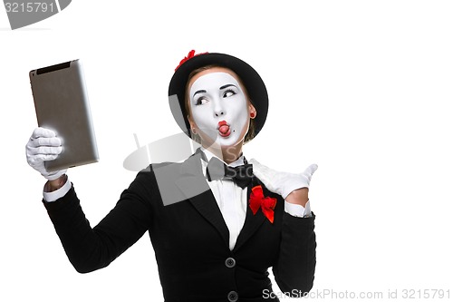 Image of business woman in the image mime holding tablet PC