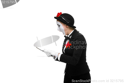 Image of business woman in the image mime holding tablet PC