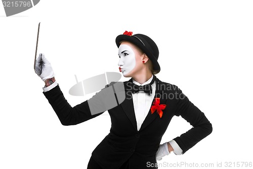 Image of business woman in the image mime holding tablet PC