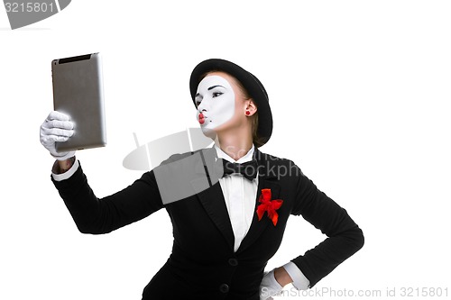 Image of business woman in the image mime holding tablet PC