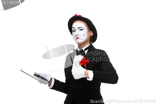 Image of business woman in the image mime holding tablet PC