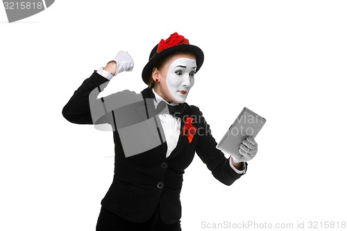 Image of business woman in the image mime holding tablet PC