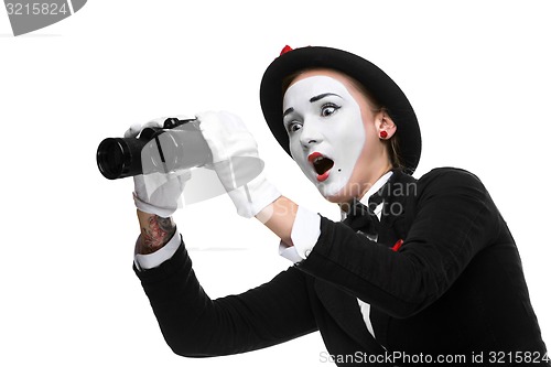 Image of Portrait of the surprised and joyful mime with binoculars