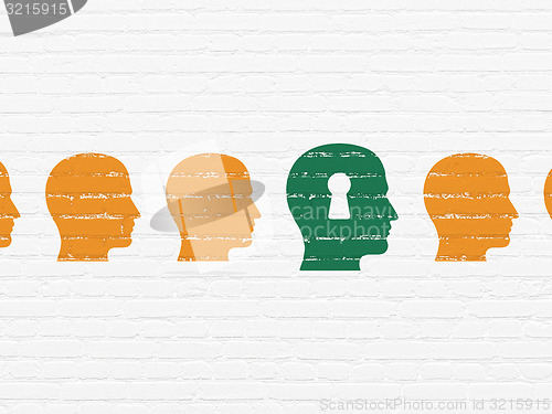 Image of Finance concept: head with keyhole icon on wall background