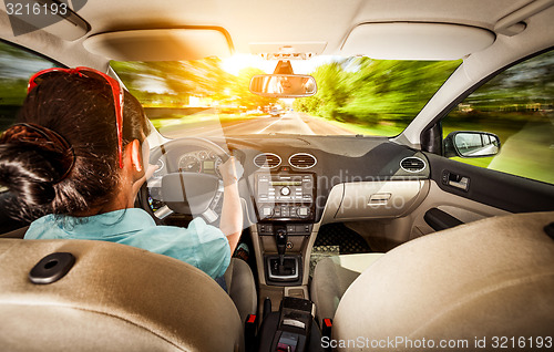 Image of Woman behind the wheel of a car.