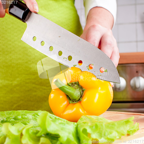 Image of Woman\'s hands cutting vegetables