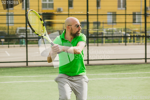 Image of man play tennis outdoor
