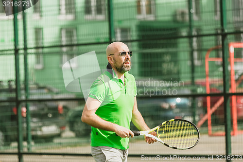 Image of man play tennis outdoor