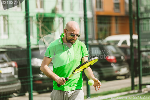 Image of man play tennis outdoor