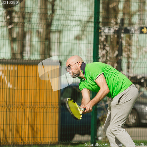 Image of man play tennis outdoor