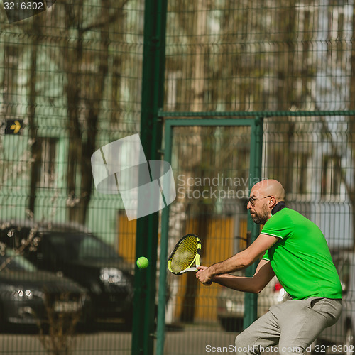 Image of man play tennis outdoor