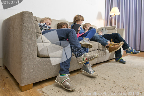 Image of Bored children gaming on a couch