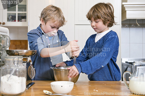 Image of Boys mixing dough in a bowl using a whisk