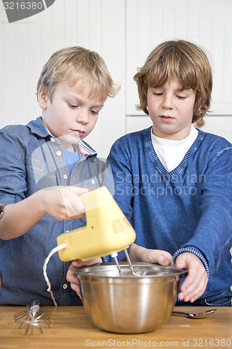 Image of Boys mixing dough in a bowl