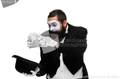 Image of mime as a businessman laying dollars in hat