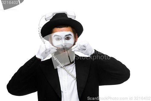 Image of man in the image mime holding a handset. 