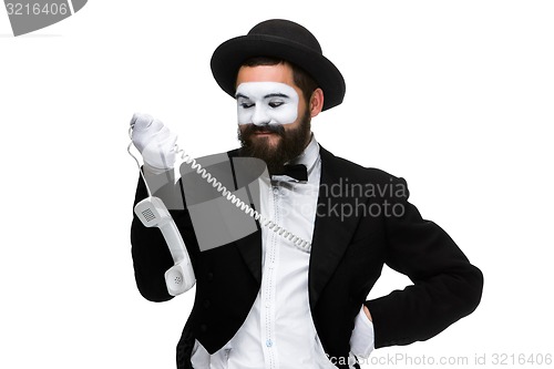 Image of man in the image mime holding a handset. 