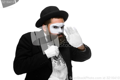 Image of mime as businessman putting money in his pocket