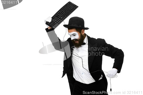 Image of Angry mime as a businessman is destroying  keyboard
