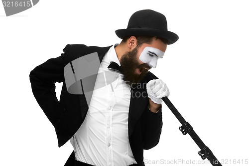 Image of portrait of a man as mime with tube or retro style microphone