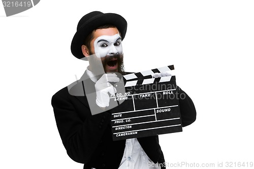 Image of man in the image mime with movie board