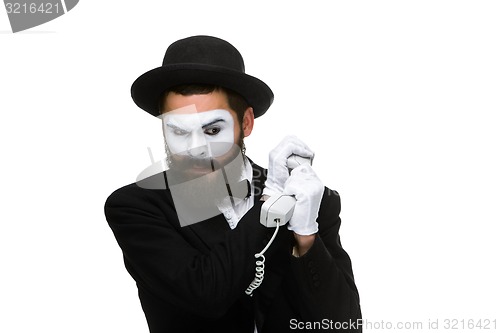 Image of man in the image mime holding a handset. 