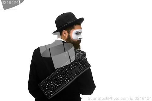 Image of mime as a businessman holdinga keyboard behind