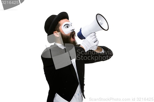 Image of Man with a face mime screaming into megaphone 